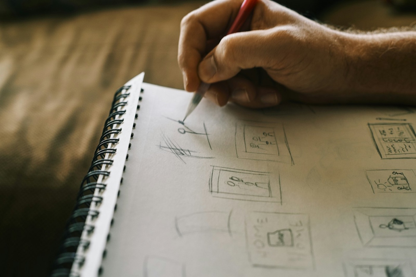 Hands writing ideas in a notebook